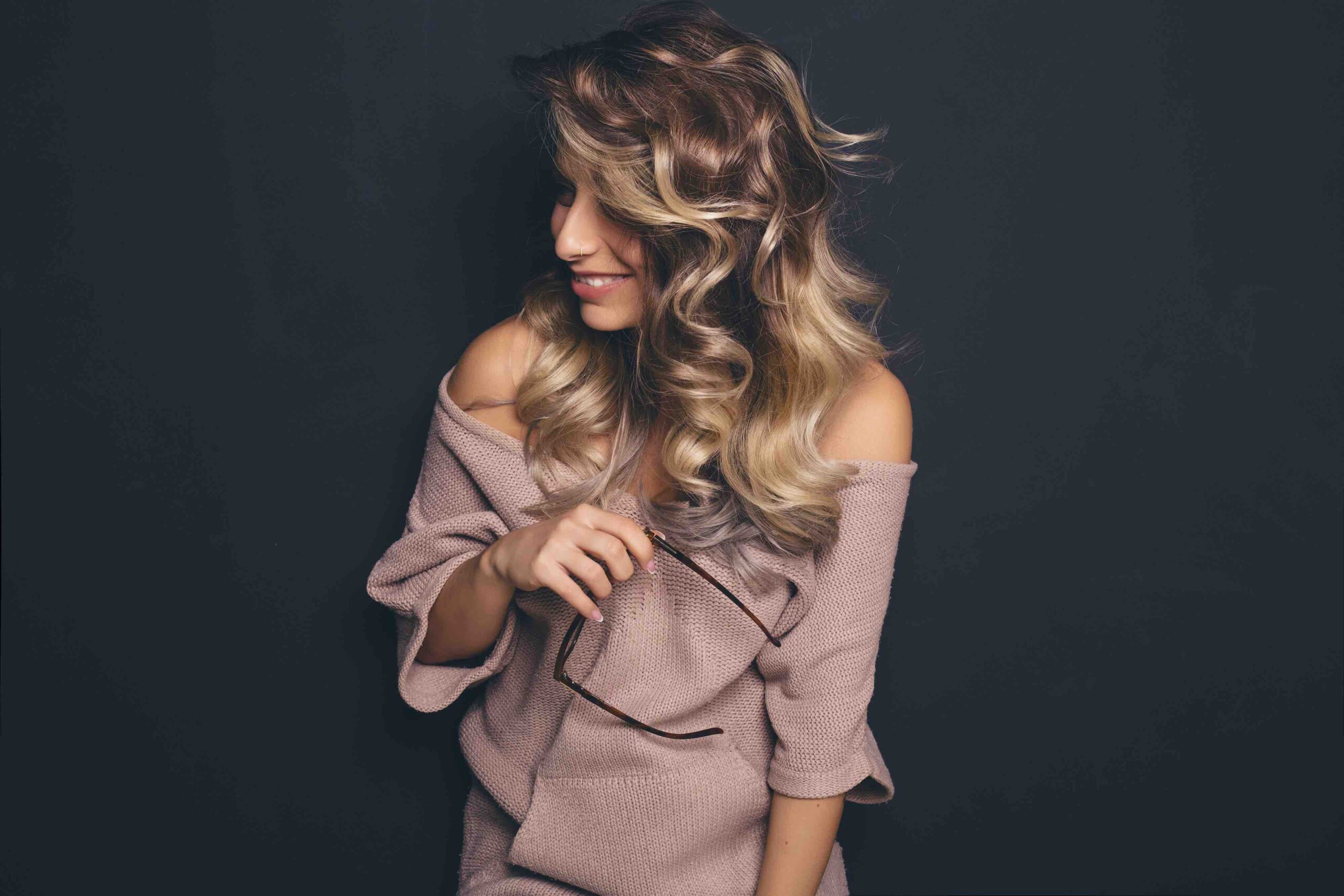 A young woman with long waves in Balayage Hair Colour